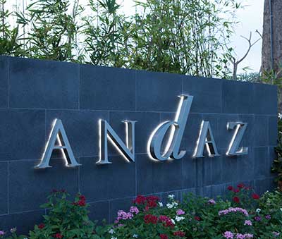 Andaz Hyatt Resort - Polished stainless steel reverse-halo-lit letters mounted on granite faced wall. Halo lit with LEDs.