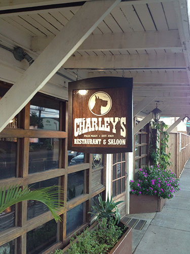 Charley's - Varnished mahogany marine plywood blade sign with MDO border. Applied vinyl graphics.