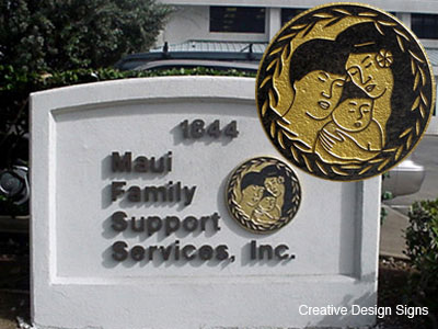 Family Services - Bronze letters on architecture wall with carved granite gold-leaf logo.