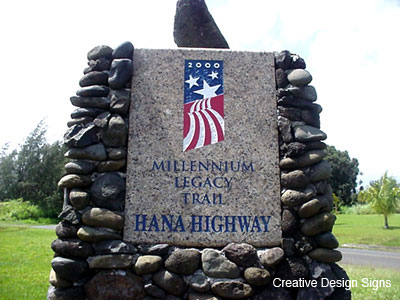 Millennium Trail Monument - Etched granite and painted plaque with cast cement base faced with etched river stones from 22 Maui communities linked by the ancient trail of Hana Highway.