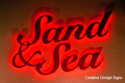 Sand and Sea - Waterjet cut HDU letters. Stud mounted. Halo lit with LEDs.